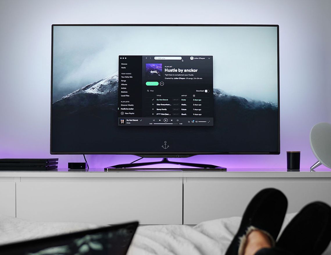 A woman streaming music on her TV