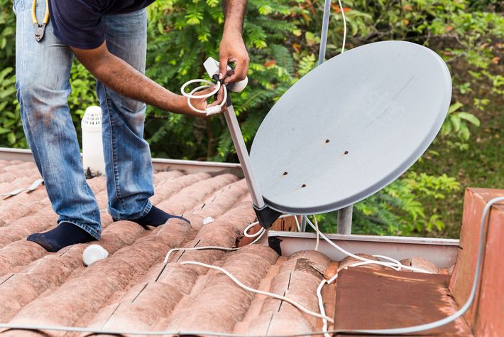 Engineer installing satellite 